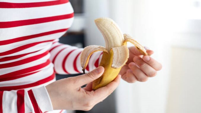 Woman hands peeling a banana