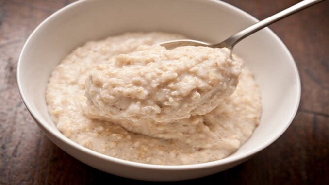 bowl of Oatmeal ( Porridge ) from above with spoon.